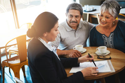 Hispanic couple consulting with case worker