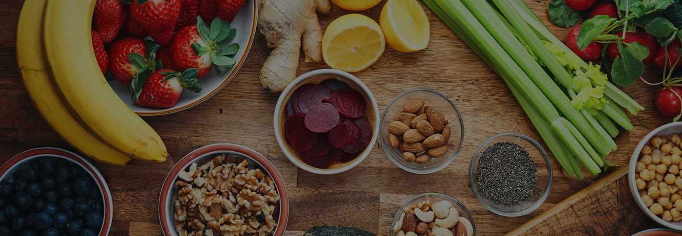 Colorful Assortment of Healthy Superfoods with Fresh Fruits, Vegetables, Nuts, Seeds, and Whole Grains Arranged on a Rustic Wooden Table